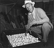 Bing Crosby displays golfballs for the scrap rubber drive during World War Two