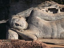 Lord Buddha entering Parinibbana at the Gal Vihara in Polonnaruwa. The Gal Viharaya in Polonnaruwa has four large images of the Buddha carved out of a single rock.