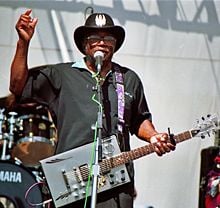 Bo Diddley performing in a 2006 concert.
