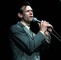 Randy Travis sings his chart-topping song "Three Wooden Crosses," at the DoD-sponsored salute to Korean War veterans at the MCI Center in Washington, July 26, 2003.