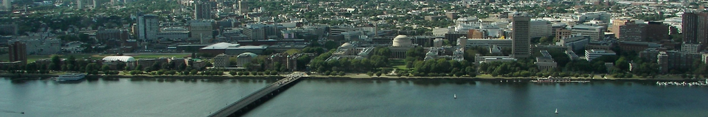 Northward view of MIT's campus along the Charles River. Undergraduate dormitories MacGregor House, Burton-Connor House, Baker House, and McCormick Hall, as well as graduate dormitory Ashdown House, can be seen to the west of the Harvard Bridge and Massachusetts Avenue. The Maclaurin buildings and Killian Court can be seen at the center of the image. The Green Building, Walker Memorial, Media Lab, and high-rise offices and laboratories in Kendall Square can be seen to the east.