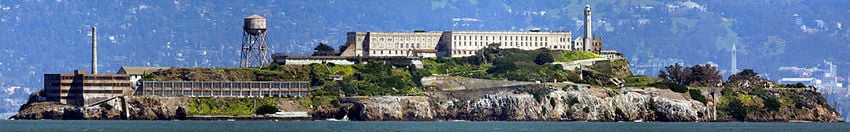 A panorama of Alcatraz as viewed from San Francisco Bay, facing east. Sather Tower and UC Berkeley are visible in the background on the right.