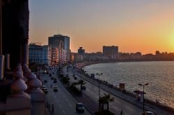 Sunset illuminates the promenade of Alexandria's waterfront.