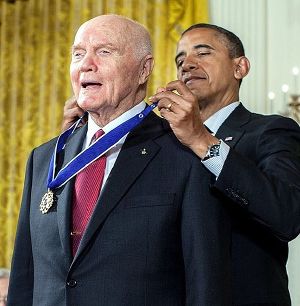 Barack Obama putting on Glenn's Medal of Freedom from behind