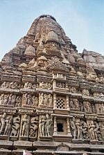 A typical temple at Khajuraho with divine couples. Note lace-like ornamentation on the major and the minor shikharas.