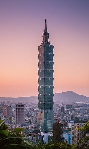 Photo of Taipei 101 tower against a blue sky.