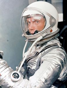 Glenn in a silver spacesuit