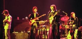 The Band with Bob Dylan in 1974. Left to right: Rick Danko on bass, Robbie Robertson on guitar, Dylan, and Levon Helm on drums.