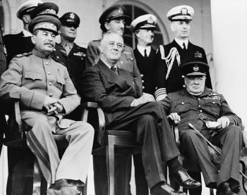 Tehran, Iran, Dec. 1943—Front row: Marshal Stalin, President Roosevelt, Prime Minister Churchill on the portico of the Soviet Embassy—Back row: General H.H. Arnold, Chief of the U.S. Army Air Force; General Alan Brooke, Chief of the Imperial General Staff; Admiral Cunningham, First Sea Lord; Admiral William Leahy, Chief of staff to President Roosevelt, during the Tehran Conference